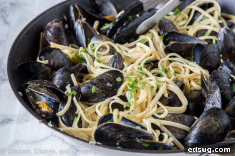 Seaside Mussels Linguine 3 A close-up shot of a bowl of linguine with mussels, garnished with fresh parsley.
