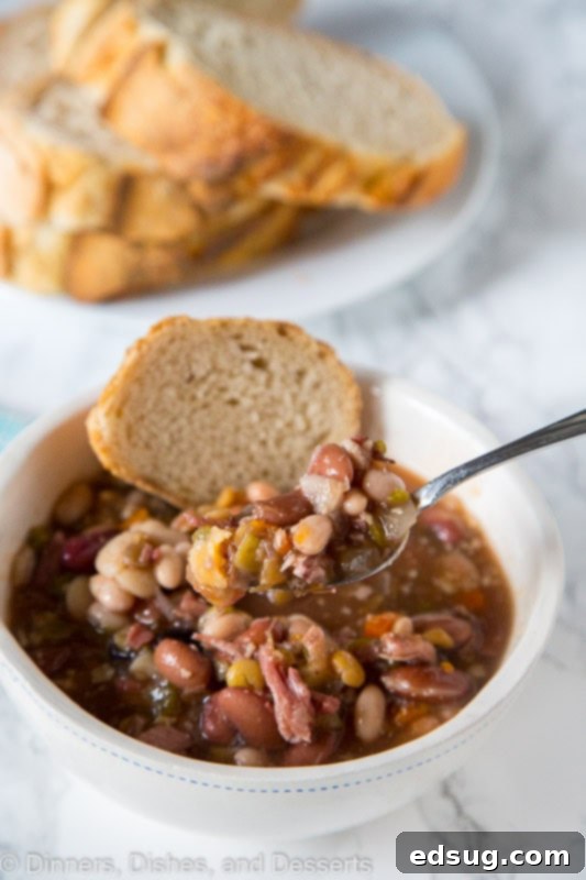A close-up of a rustic bowl of Ham and Bean Soup, showcasing its hearty ingredients.