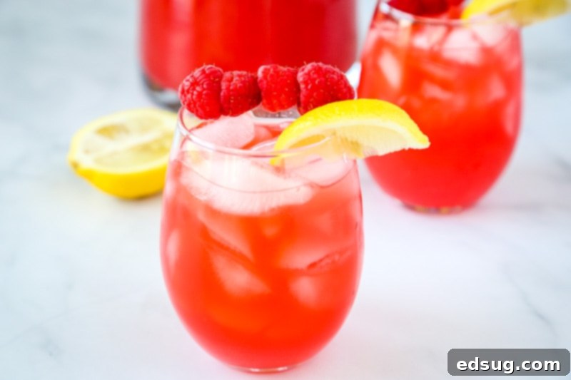 Raspberry Lemonade - Pureed raspberries give fresh squeezed lemonade such a great new flavor!  So easy to make and the perfect refreshing summer drink!