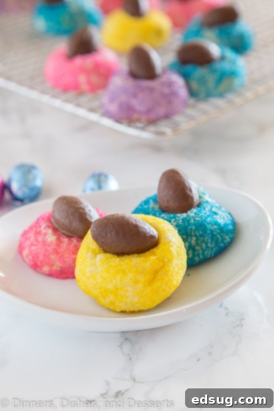 Dainty Chocolate Egg Blossoms 3 A plate of colorful Mini Chocolate Egg Blossom Cookies, showcasing various sugar colors and chocolate egg toppings.