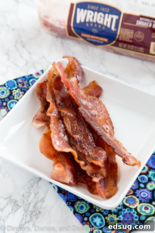 Close-up of crispy, perfectly cooked Wright Brand Bacon slices on a plate.
