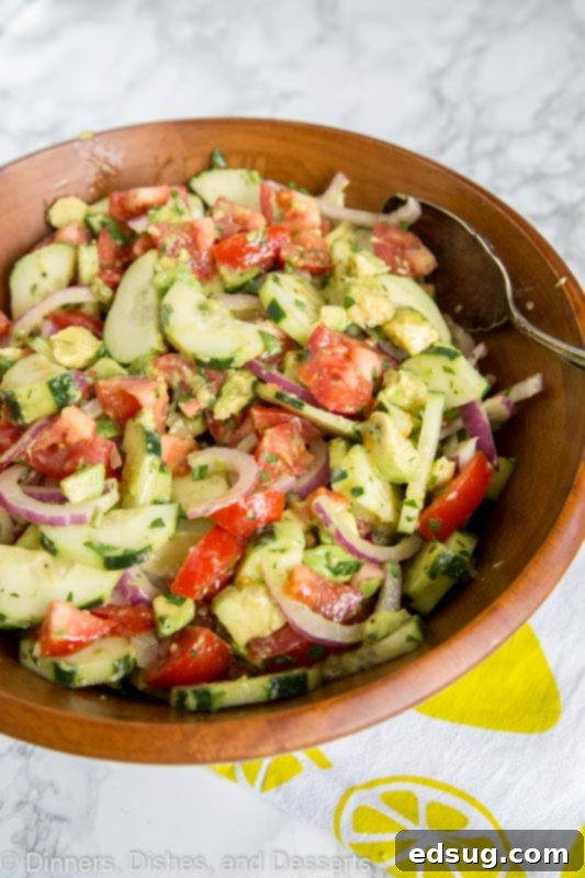 Garden Fresh Tomato Cucumber Medley 3 A bowl of food on a plate, with Salad and Cucumber, tomato, avoacdo