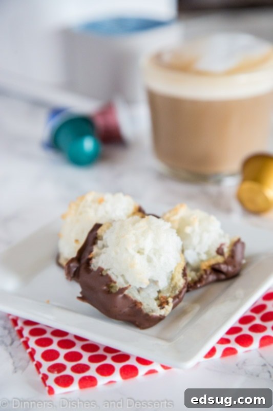 Chocolate dipped coconut macaroons neatly arranged on a plate