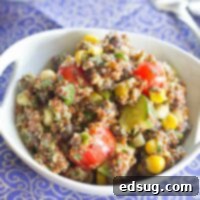 Quinoa Salad with corn, black beans, grape tomatoes, and zucchini, then topped with a creamy avocado dressing. Great warm or cold, so it is perfect for a picnic or barbeque