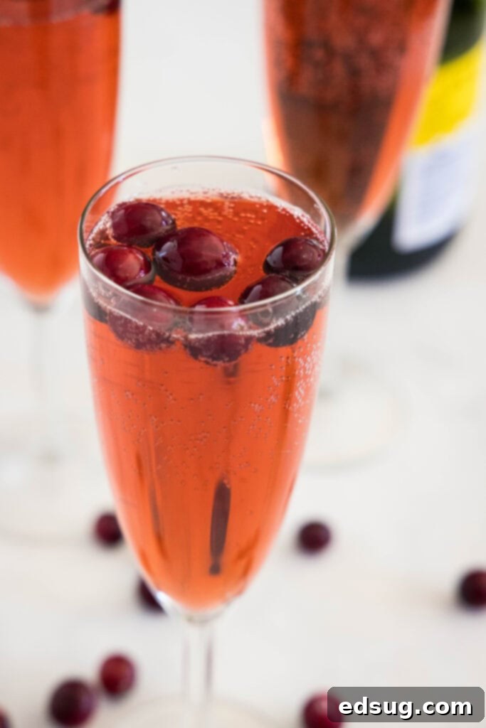 Beautiful Cranberry Mimosa served in a champagne glass, ready for a toast