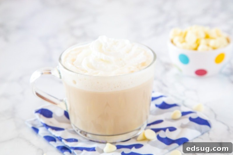 A cup of coffee on a table, with Chocolate and White chocolate
