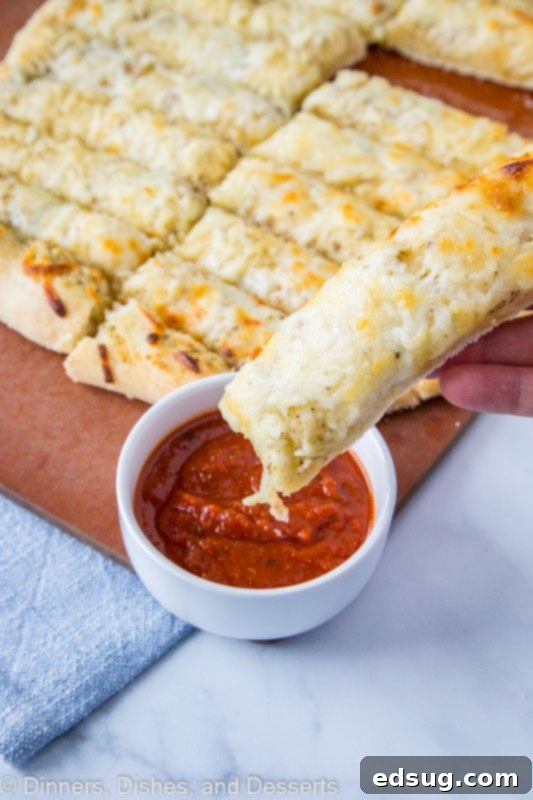Homemade cheese breadsticks with dipping sauce