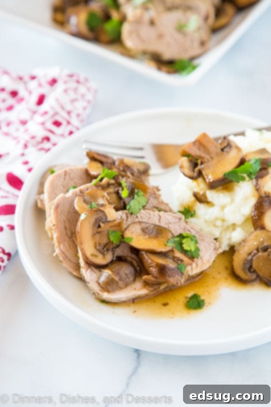 A wholesome dinner plate featuring Instant Pot Pork Tenderloin and its creamy mushroom sauce, served alongside vibrant green beans and fluffy mashed potatoes, creating a complete and satisfying meal.