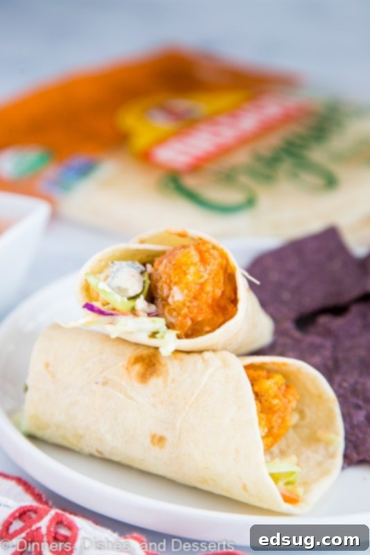A perfectly assembled Crispy Buffalo Chicken Wrap on a plate, ready for a delicious lunch or dinner.