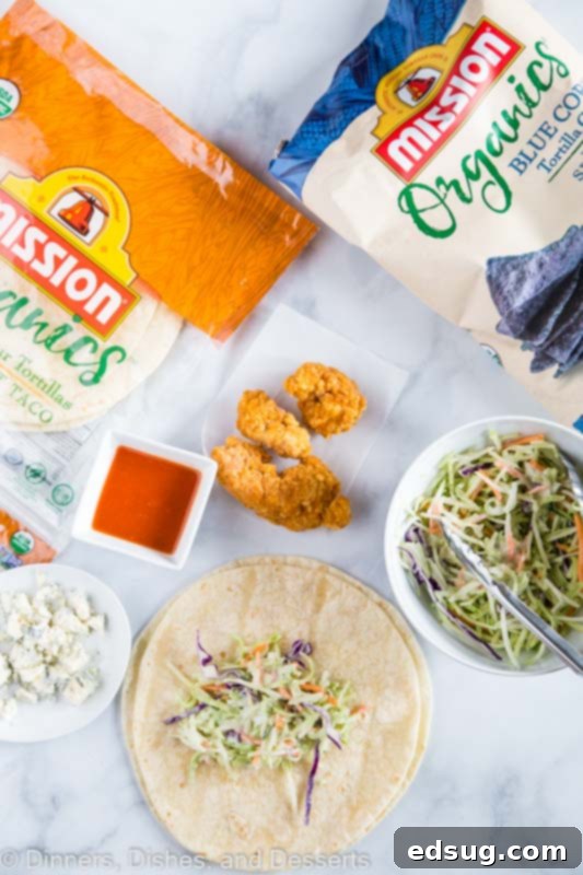 A tray of ingredients laid out for making Crispy Buffalo Chicken Wraps, showcasing fresh and vibrant components.