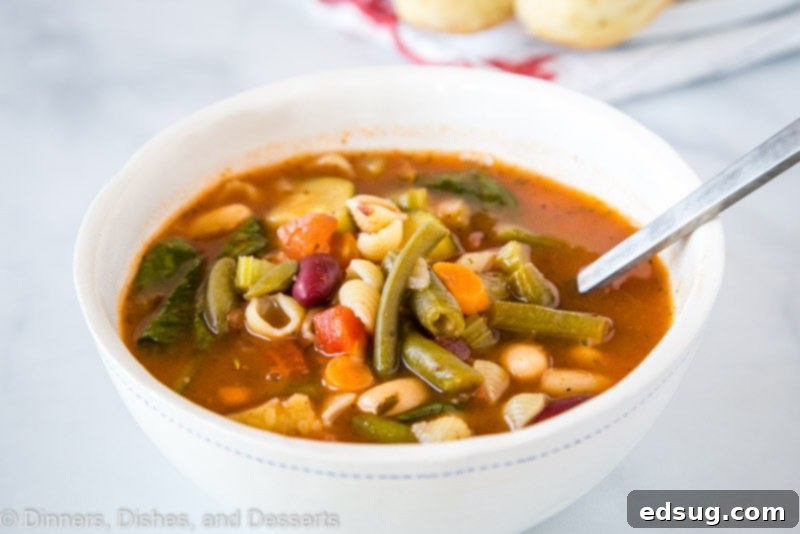 Olive Garden's Hearty Minestrone Soup 5 An overhead shot of a large pot of Olive Garden Minestrone Soup, showcasing its rich red broth, a variety of colorful vegetables, and small pasta, signifying a generous, family-style serving.