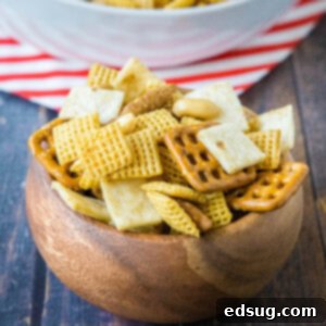 Fiesta Taco Crunch 5 Close up of Mexican snack mix in a wood bowl, with individual pieces clearly visible and coated in spice.