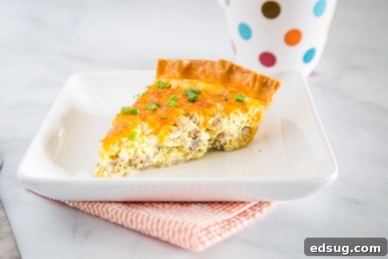 Sausage Quiche - An easy quiche recipe that is perfect for brunch or even a light dinner. Flaky pie crust with an egg custard that is loaded with breakfast sausage, onions and plenty of cheddar cheese.