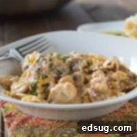 A hearty bowl of Pasta Milano, loaded with chicken, mushrooms, and bowtie pasta in a rich sauce.