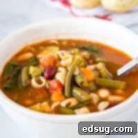 A steaming bowl of Olive Garden Minestrone Soup, rich with vegetables and pasta.