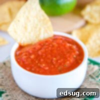 A vibrant bowl of fresh Chili's Salsa, ready to be scooped with tortilla chips.