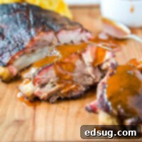 Slow-Smoked Baby Back Ribs 8 Smoked Baby Back Ribs - perfect fall off the bone ribs with a modified 3-2-1 method that comes out perfect every time!