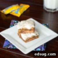 Butterfinger Crunch Blondies 2 Close-up of a frosted Butterfinger Blondie, showcasing the rich texture and candy pieces