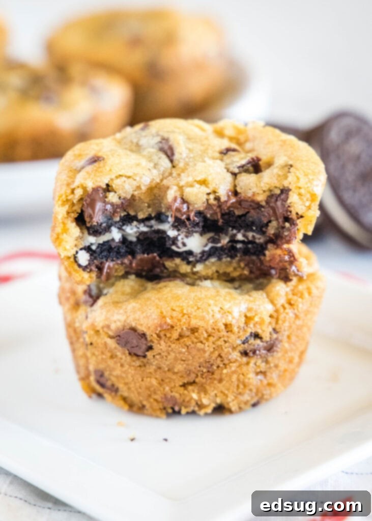 Chocolate Chip Cookies with an Oreo Center 2 Stacked Oreo stuffed chocolate chip cookies on a plate with one showing a bite taken out, revealing the Oreo inside.