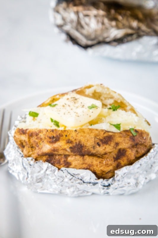 Grill-Baked Potatoes 5 baked potatoes on the grill with butter and chives