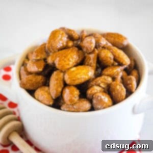 close up spicy honey roasted almonds in white bowl