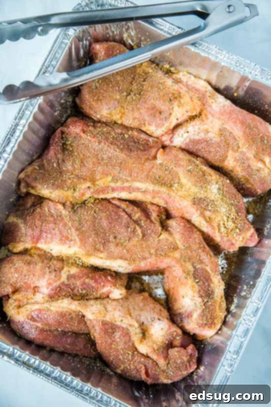 Hearty Smoked Country Style Ribs 3 country style ribs rubbed with spices in pan