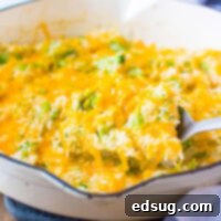 Cheesy Broccoli Rice Casserole 7 cropped in pic of rice casserole on serving spoons