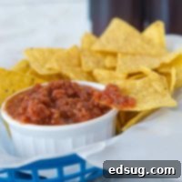 homemade salsa in a white bowl with chips