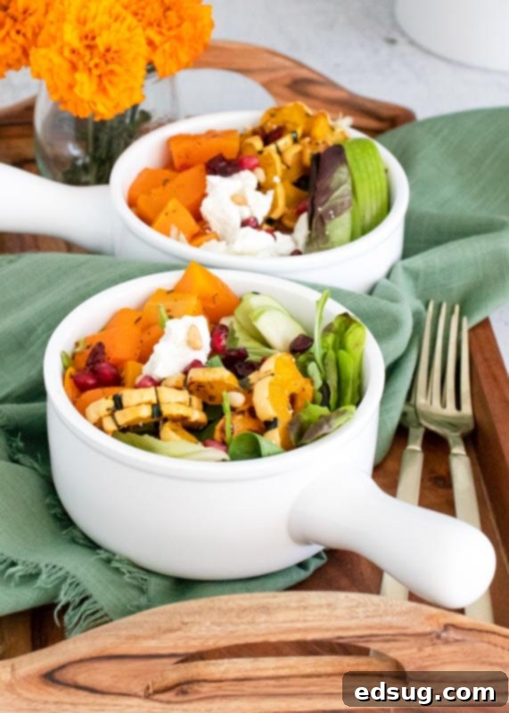 Two bowls of autumnal goat cheese salad arranged on a elegant tray, ready to be served.