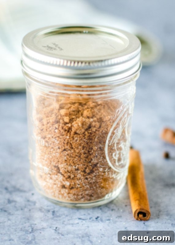 Mason jar filled with hot buttered rum mix, showing the layers of sugar and spices
