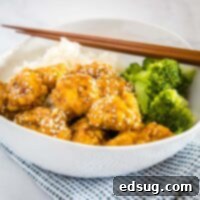 cropped sesame chicken picture with broccoli in white bowl