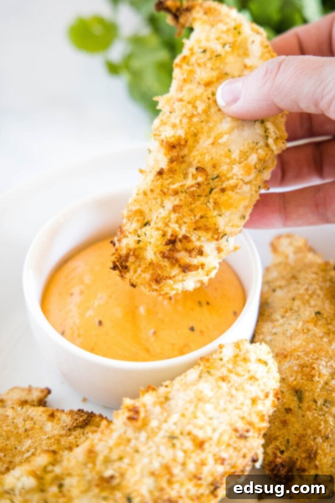 Crispy Air Fryer Chicken Tenders 2 Dipping air fryer chicken tenders into homemade Cane's sauce