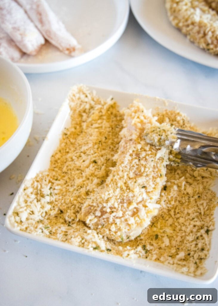 Crispy Air Fryer Chicken Tenders 3 Process of making chicken tenders with three bowls for breading