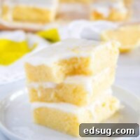 Lemon Brownies on a plate with a bite taken out.