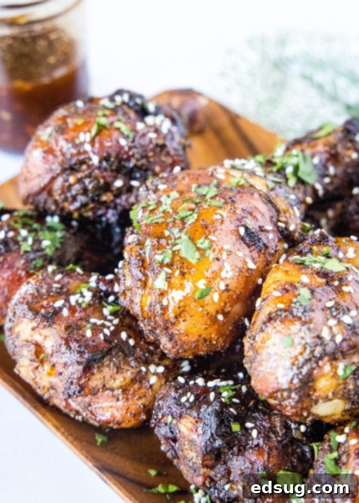 Chicken legs coated in a glossy, red Asian BBQ sauce on a platter