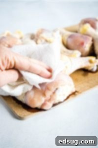 Patting chicken dry before adding spices for better adherence