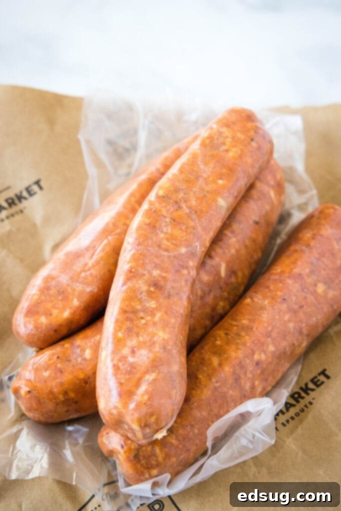 Raw Italian sausages resting on butcher paper, showcasing their fresh appearance before being cooked in an air fryer.