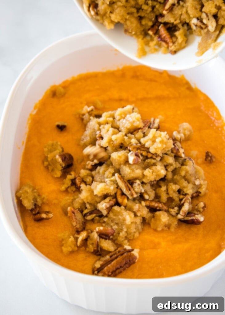 sprinkling crumb topping on sweet potato casserole