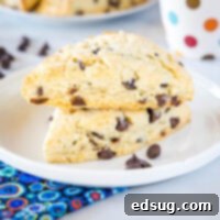 Close up of stacked chocolate chip scones on a white plate