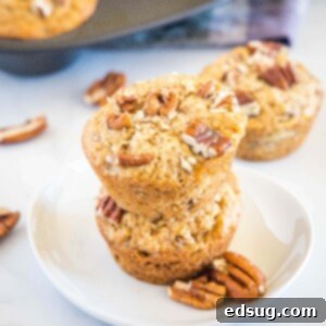 Ultimate Banana Nut Muffins 7 cropped in image of banana nut muffins on a white plate