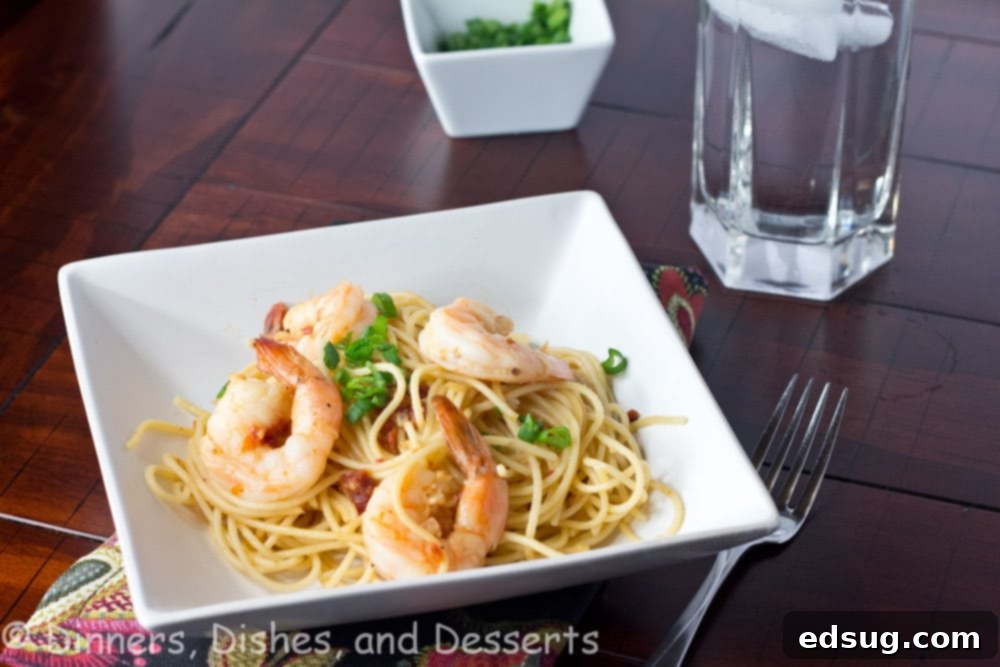 Speedy Shrimp Pasta - Plump and juicy shrimp sauteed in olive oil, garlic, and onions. Tossed with pasta for a quick and easy dinner, garnished with lemon wedges and fresh parsley.