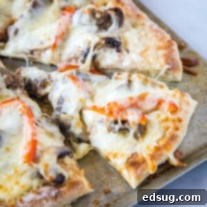 close up of slice of pizza on baking tray