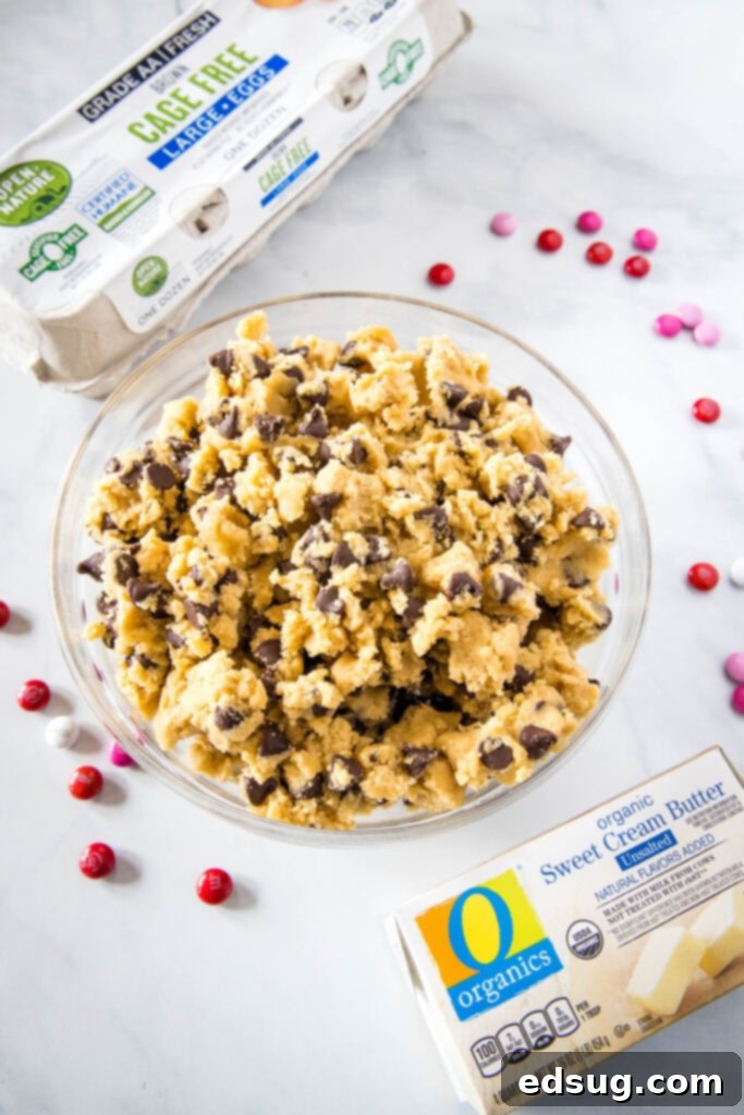 bowl of cookie dough with carton of eggs and butter