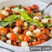 close up caprese salad in a bowl, showcasing its fresh ingredients and vibrant colors.