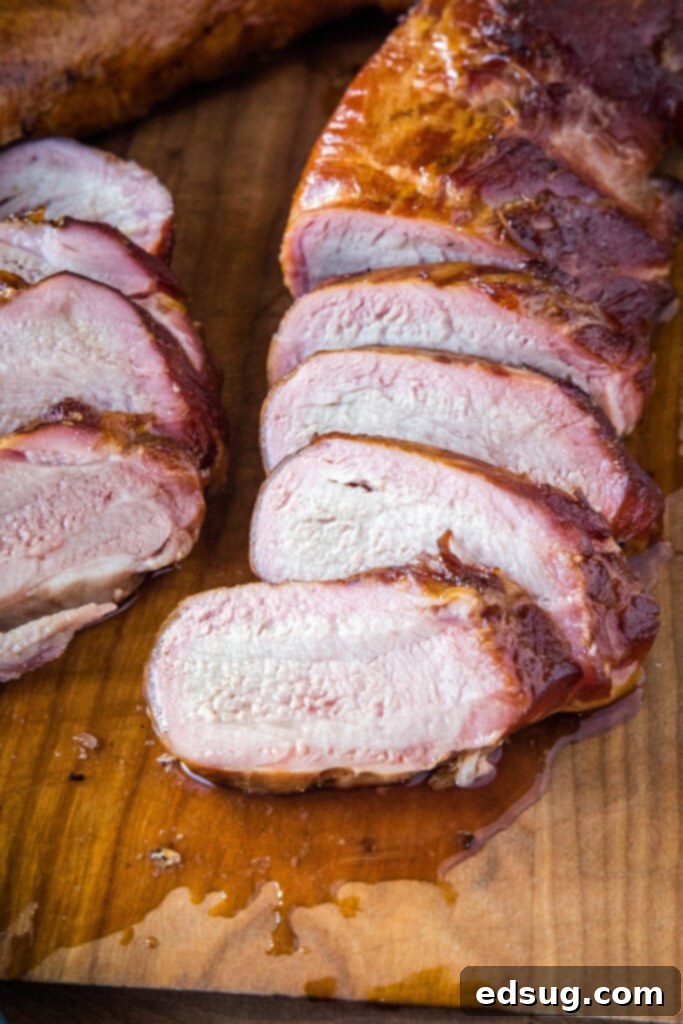 Succulent Smoked Pork Tenderloin 6 pork tenderloing sliced on a cutting board