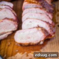 Succulent Smoked Pork Tenderloin 8 close up smoked pork tenderloin sliced on a cutting board