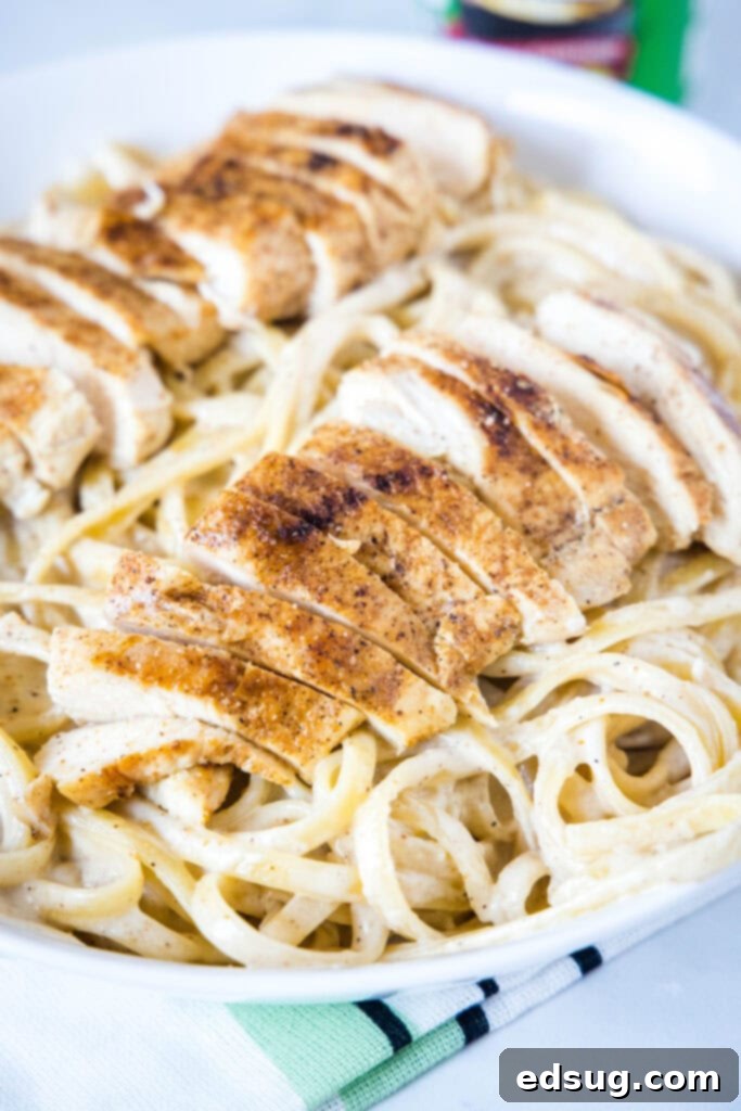 Cajun Chicken Alfredo with chicken on top, ready to serve