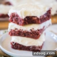 close up stack of red velvet brownies with a bite missing from one