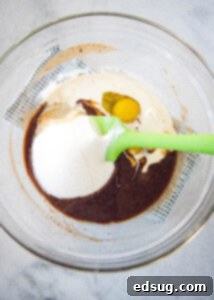 mixing sugar and eggs into melted chocolate