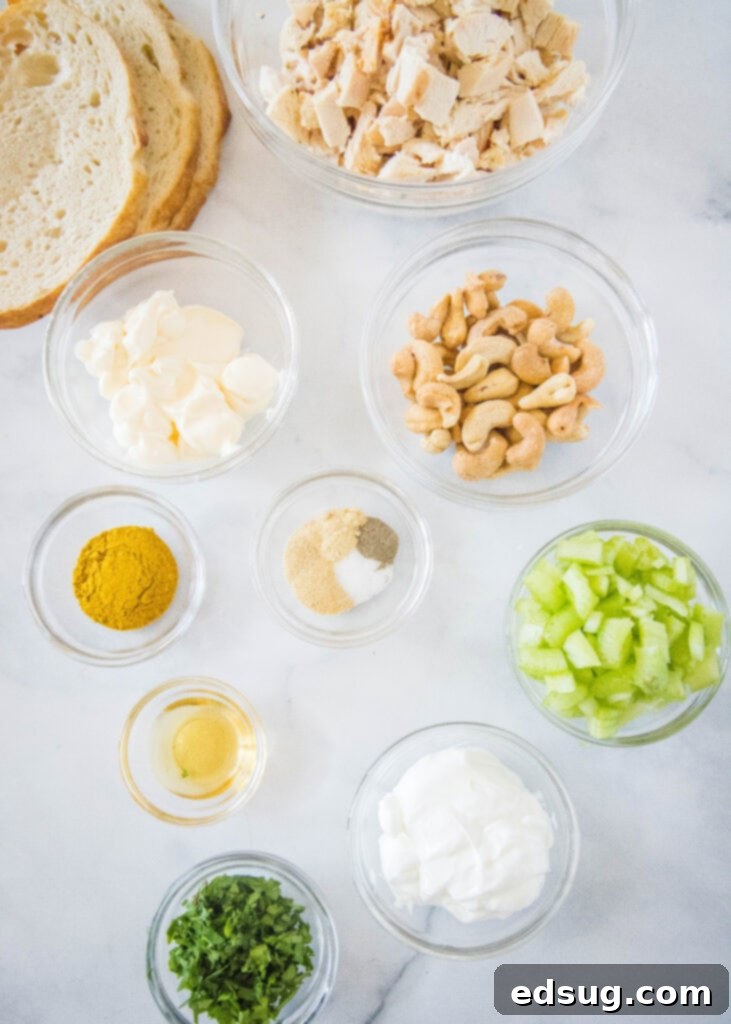 Ingredients for making curry chicken salad laid out on a counter.
